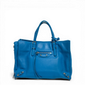 Balenciaga Classic City tote bag in blue lambskin leather with metallic studs and long tassel zippers.