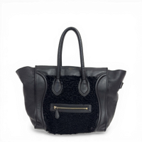 Celine Phantom Luggage tote bag in black leather and shearling with signature side wings and brass hardware.