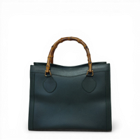 Gucci Diana tote bag in green calfskin leather featuring signature bamboo top handles.
