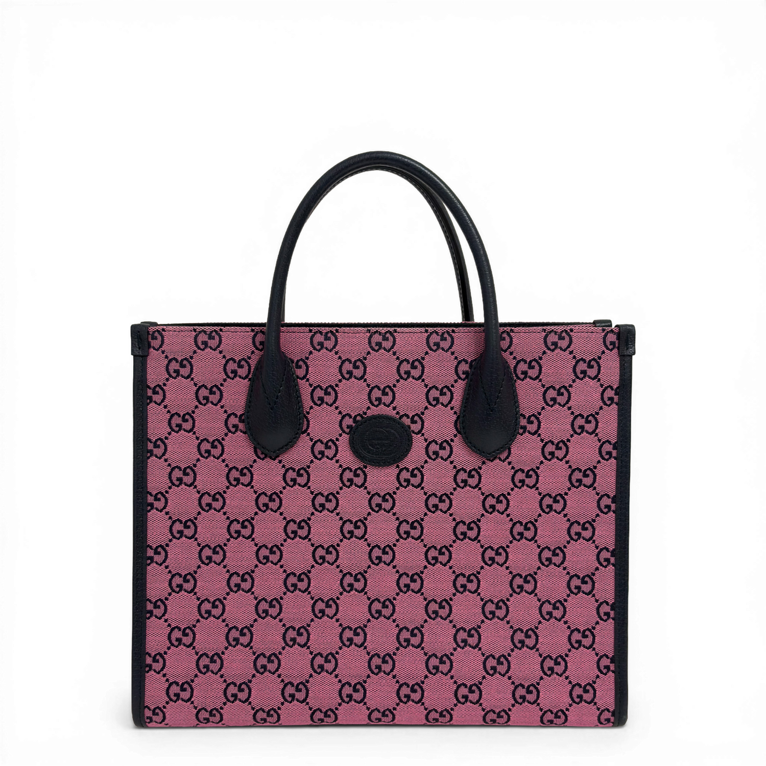Gucci GG Supreme canvas tote bag in pink with dark leather trim and top handles.