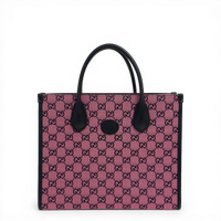 Gucci GG Supreme canvas tote bag in pink with dark leather trim and top handles.