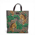 Gucci GG Supreme Tigers tote bag in beige multicolor canvas with dark brown leather trim.