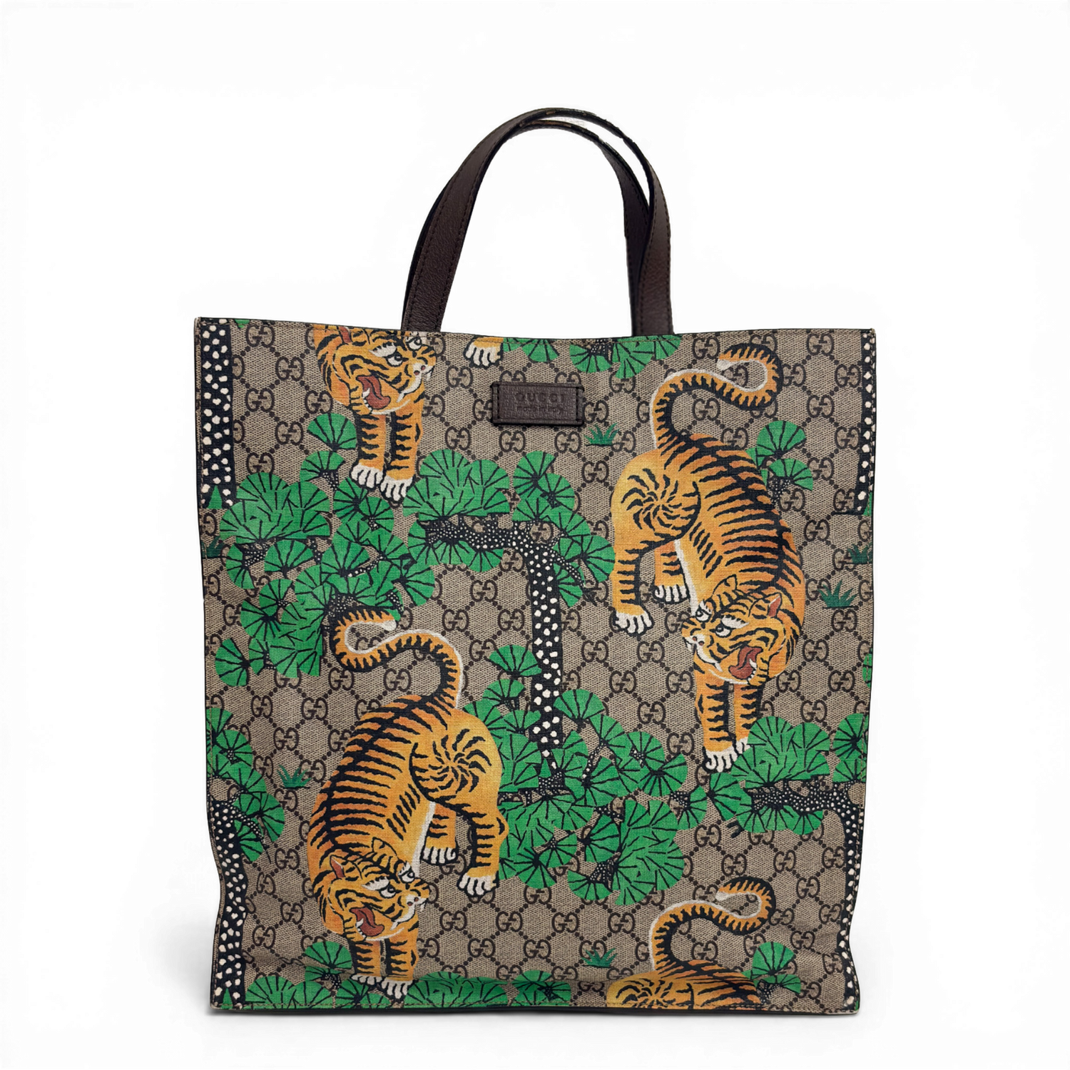 Gucci GG Supreme Tigers tote bag in beige multicolor canvas with dark brown leather trim.