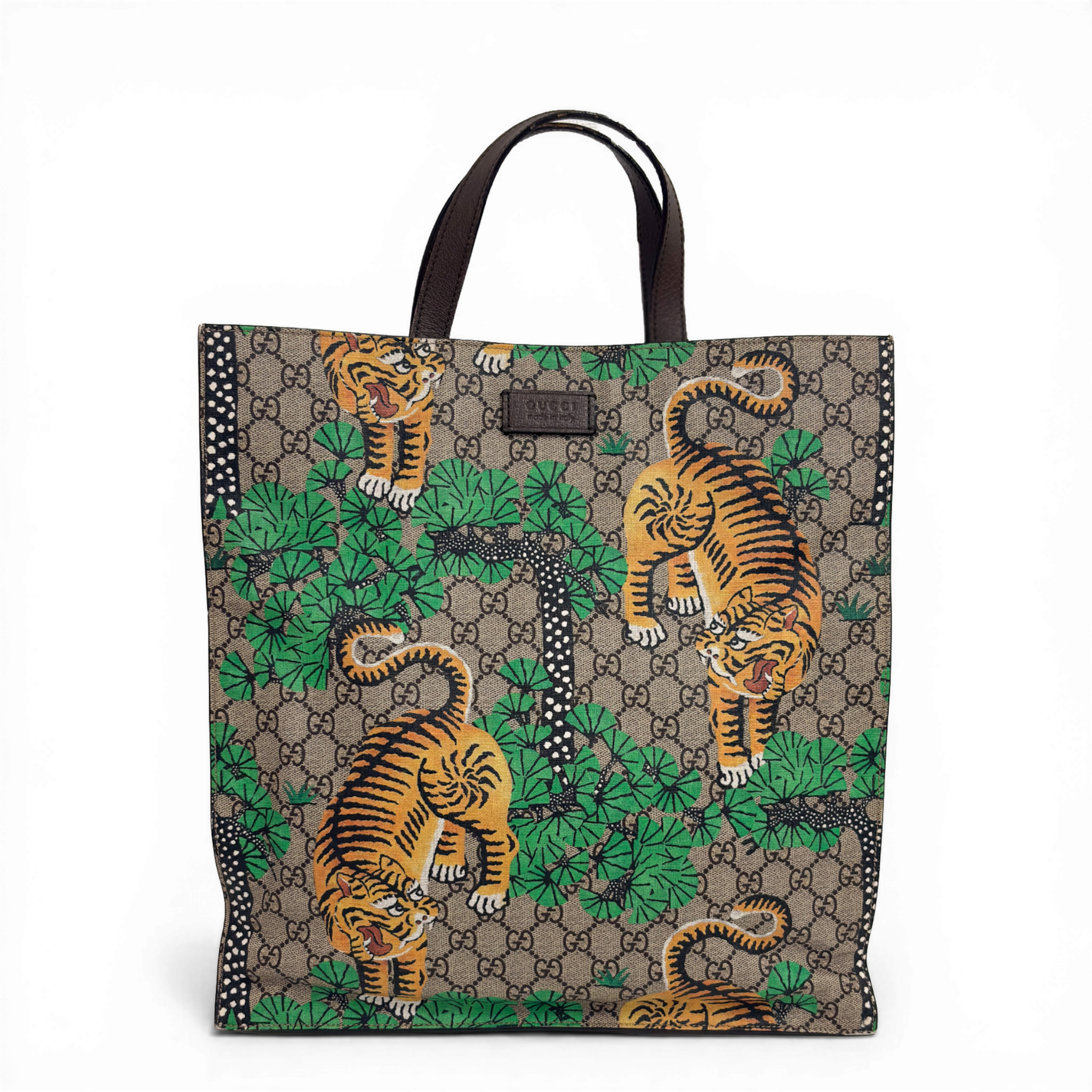 Gucci GG Supreme Tigers tote bag in beige multicolor canvas with dark brown leather trim.