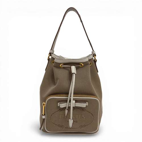 Prada Canvas Bucket Bag in beige with embroidered logo, detachable shoulder strap, and zippered pouch.